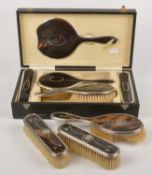 A matched five piece silver mounted and tortoiseshell dressing table set by Adie Brothers Ltd.,