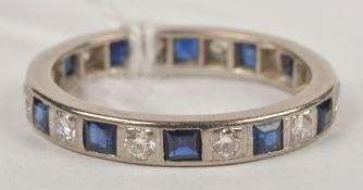 A sapphire and diamond full eternity ring, alternately set all around with square cut sapphires