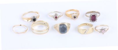 * A 9 carat two colour gold ring, set with three small brilliant cut diamonds, finger size U1/2;