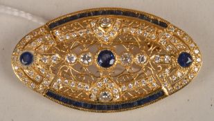 A sapphire and diamond brooch, of oval pierced design set throughout with round and calibre