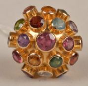 A multi gem set ring, the circular domed cluster with applied collet set amethyst, peridot, ruby