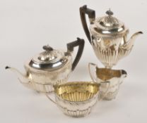 A Victorian matched silver oval four piece tea service by Goldsmiths & Silversmiths Co., London