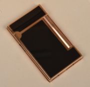 A Cigarette lighter by Dupont, black enamel case with cylindrical side mounted thumb striker, in a