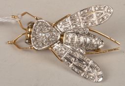 A diamond set bee brooch, with pave set thorax, abdomen and hinged wings, on a hinged double pin,