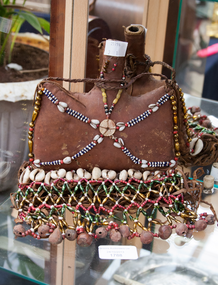 A native art beaded and padded water/wine carrier with original stopper, carrier has fringing and