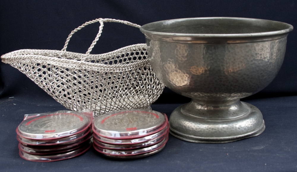 A large pewter bowl on footed plinth, with a white metal woven wine holder, etc