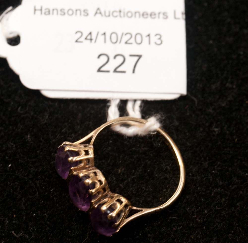 A 9ct gold and amethyst three-stone ring