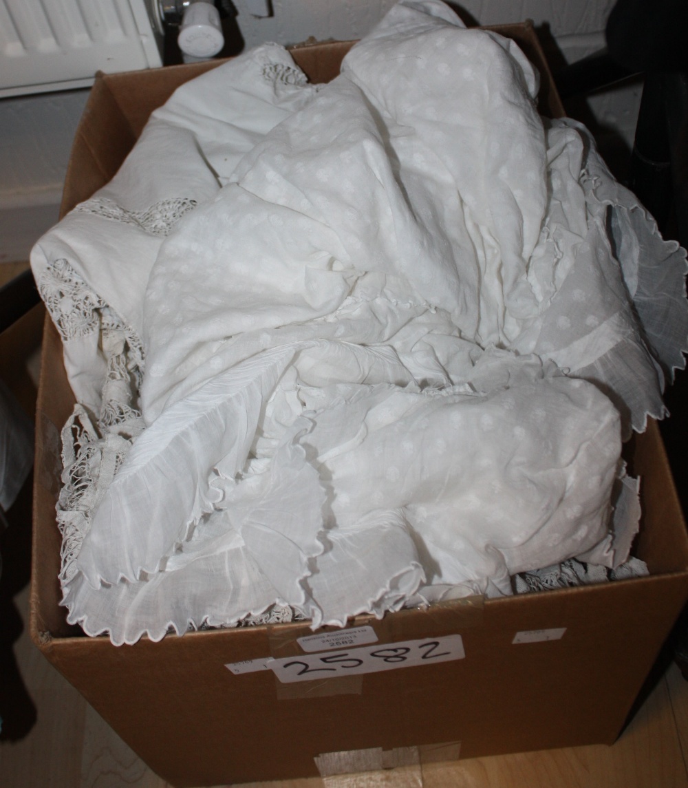 A quantity of white linen to include bedspreads, Victorian underskirts, nightdress, towels, lace