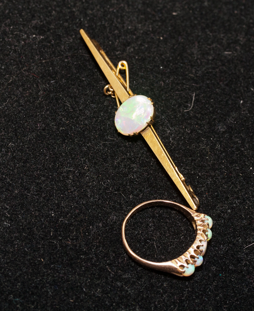 A 9ct gold and opal five-stone ring, 2.9g; and a 15ct gold and opal bar brooch, 5.7g (2)