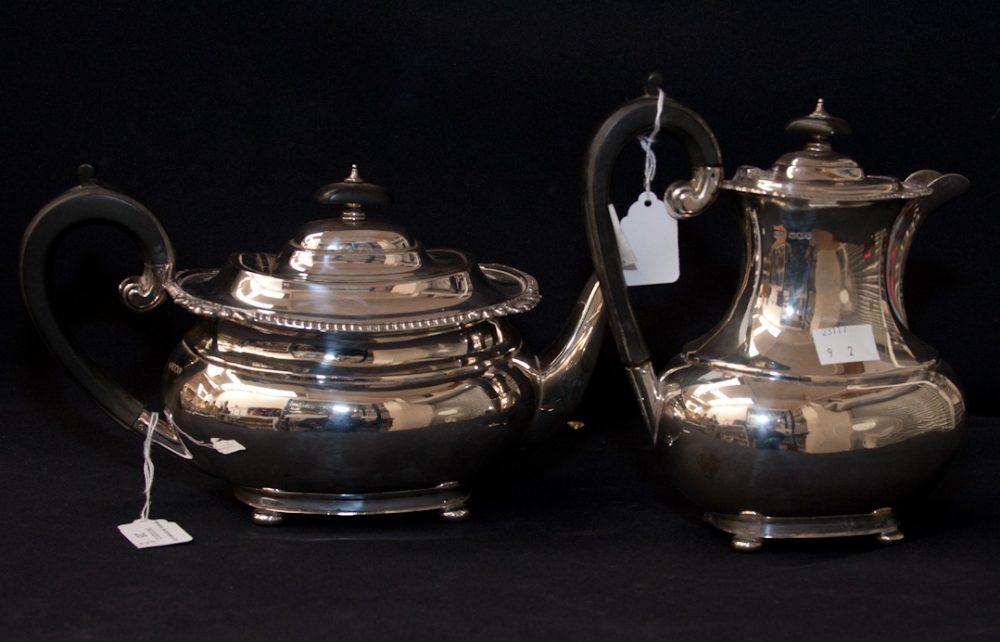 A Regency Style Silver Tea Pot and Matching Coffee Pot, both with ebony handles to hinged lids,