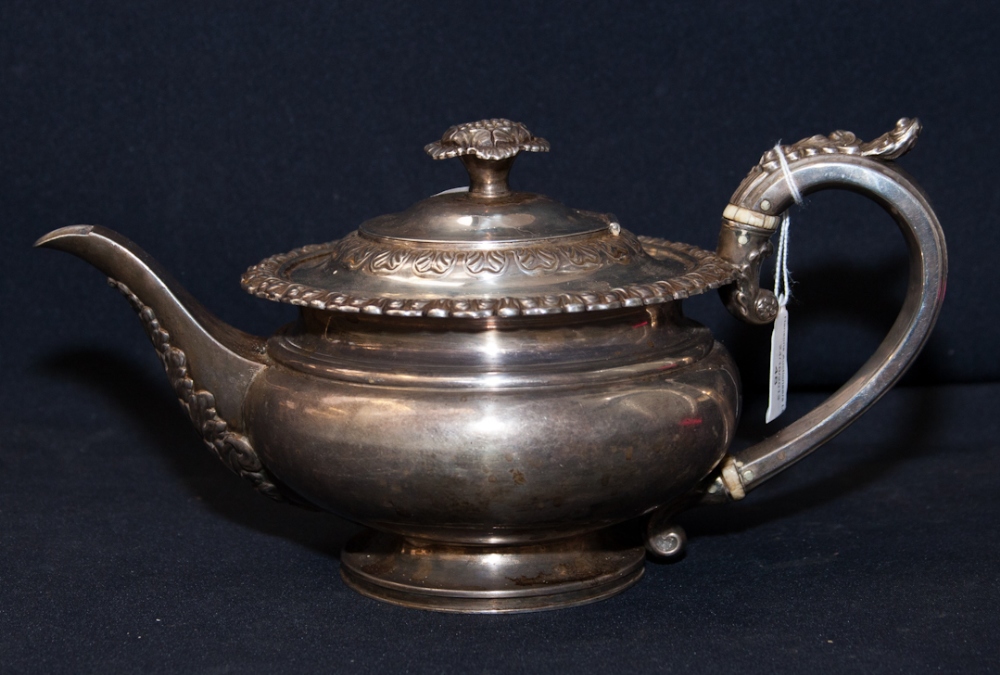 A silver tea pot, makers mark 'HB and H' Sheffield 1840 of low round form, with floral finial and