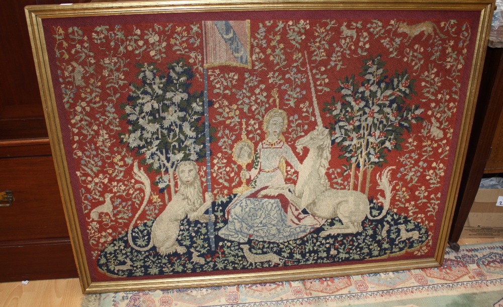 A 16th century style Lion and Unicorn wool work tapestry, in modern frame, 110cm wide, 77cm high