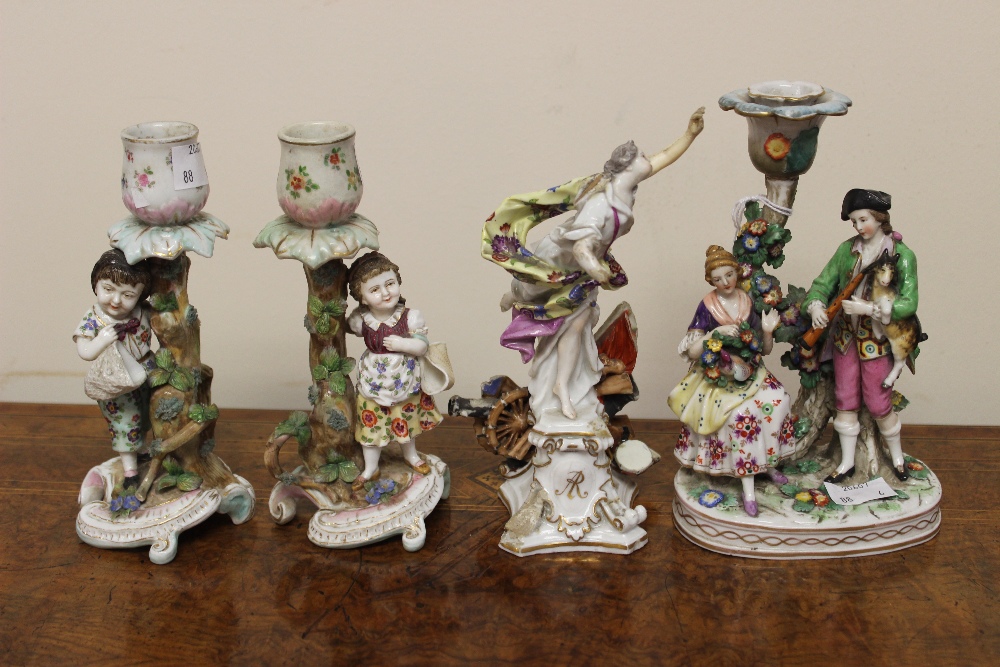 A pair of Continental figural candlesticks; another; etc (4)