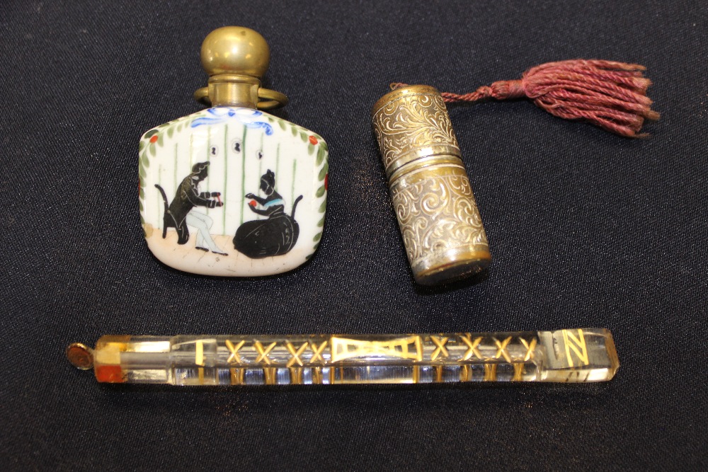 A 19th century French porcelain scent bottle; a gilded glass bottle/tube; a silvered brass bottle