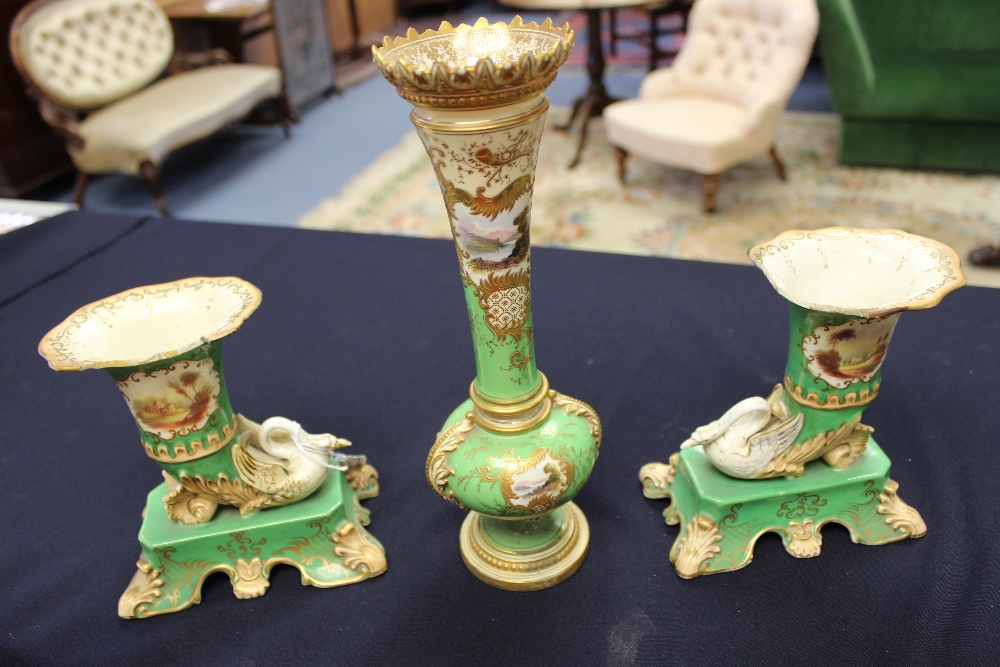 A Coalport vase, painted with scenic views, on a green ground, highlighted in gilt; and a pair of