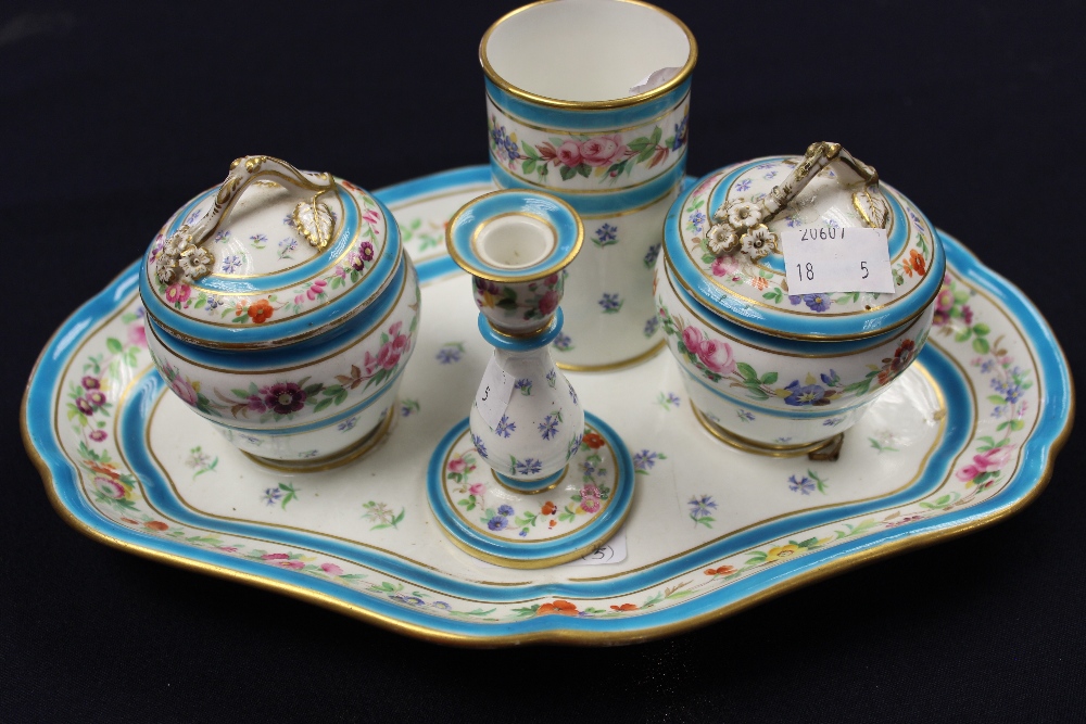 A mid-19th century Minton desk stand, two inkwells and covers with sprig handles, on a shaped