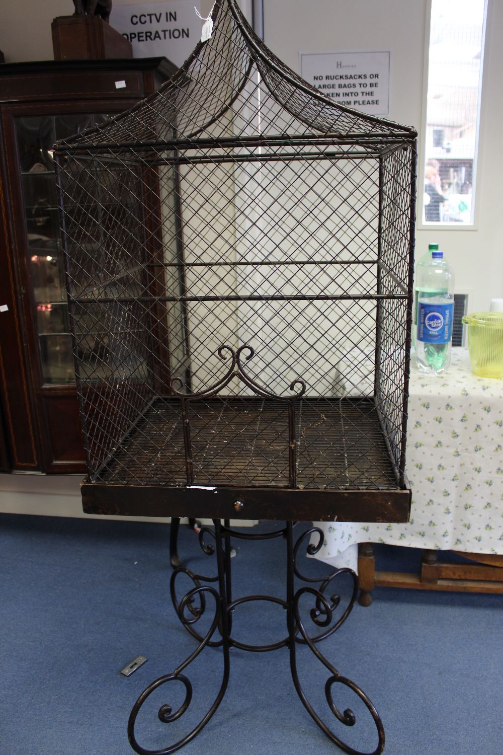 **IN RECEPTION** A large 20th century bird case on scroll stand, with bird finial