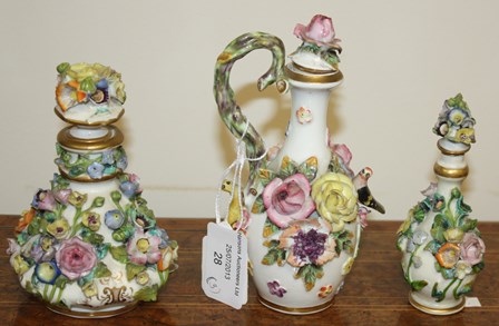 A 19th century Meissen style scent bottle and stopper, applied with flowers; another similar smaller