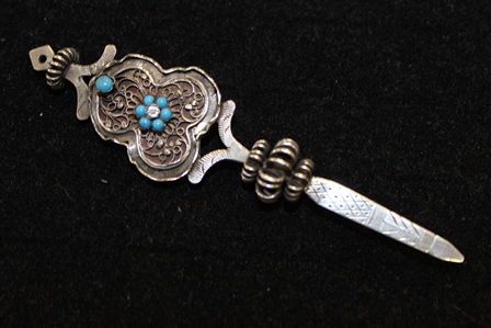 **IN RECEPTION** A late 19th century silver miniature paper knife, with filigree work set with paste