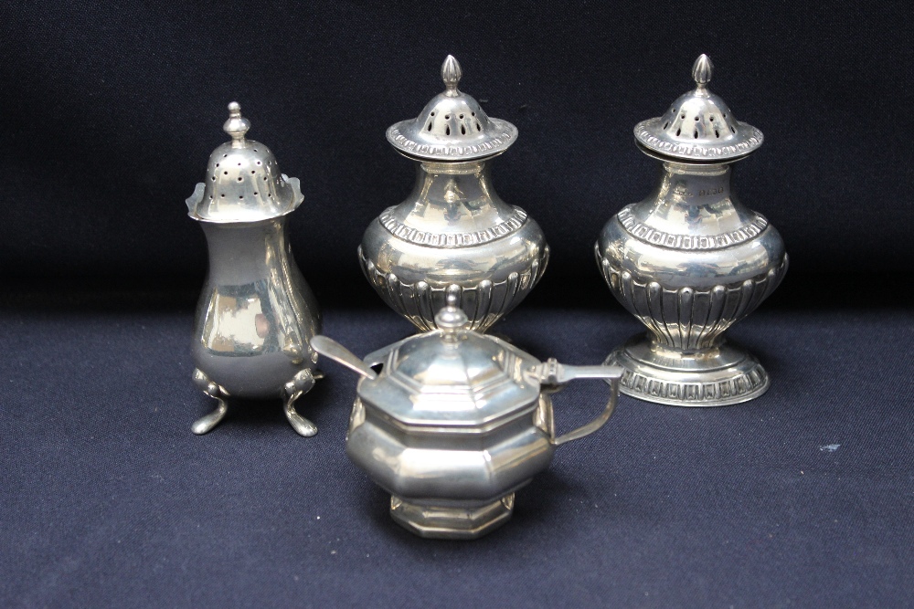 Assorted silver cruet items, three pepperettes and a mustard pot, liner and hall marked spoon (5)