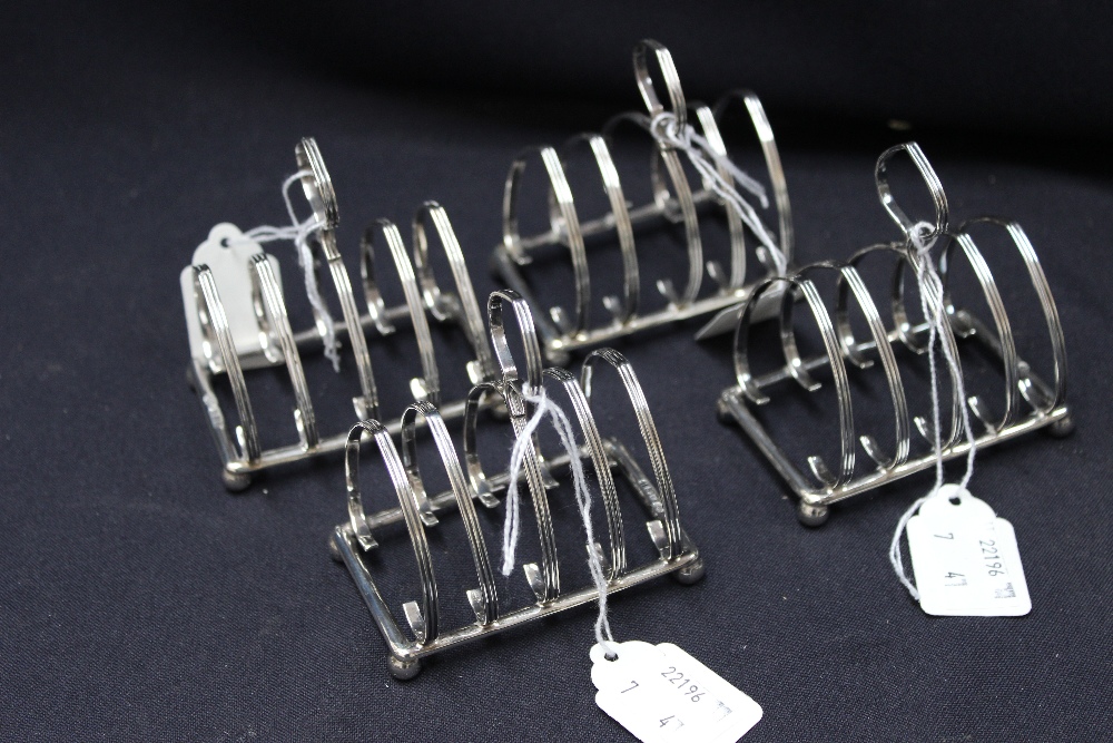 A set of four silver miniature reeded toast racks (4)