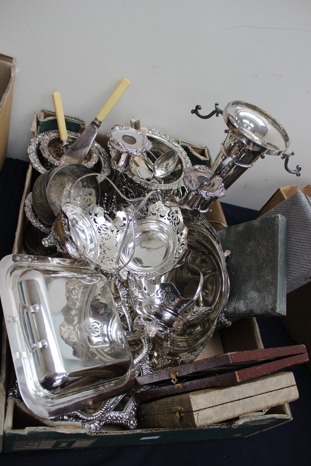 A box of good plated ware including epergne; bottle stands; entree dishes; cased flatware;