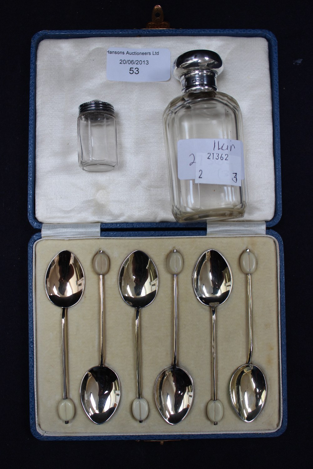 A set of six silver and enamel coffee bean spoons, and two silver items.