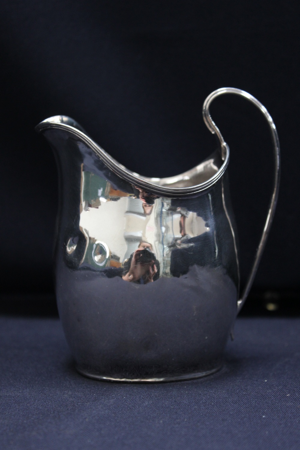 A George III silver cream jug, reeded edge