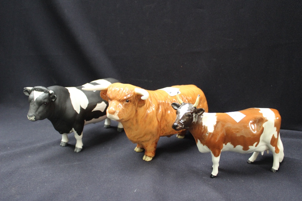 A Beswick Guernsey Cow, a Highland Cattle Bull and a Friesian Bull (3)