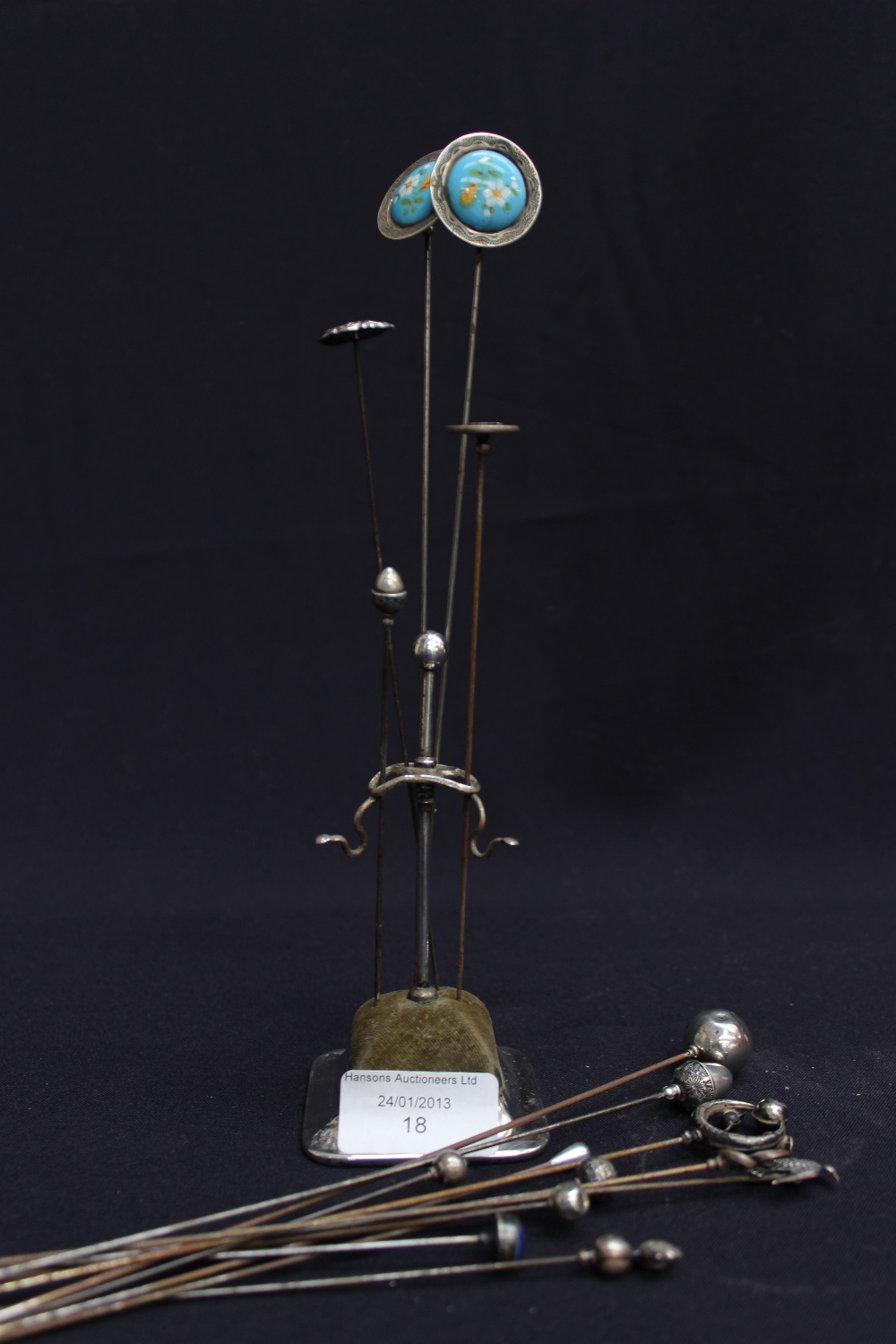 EPNS hat pin stand together with two Charles Horner hat pins and fourteen other silver hat pin tops