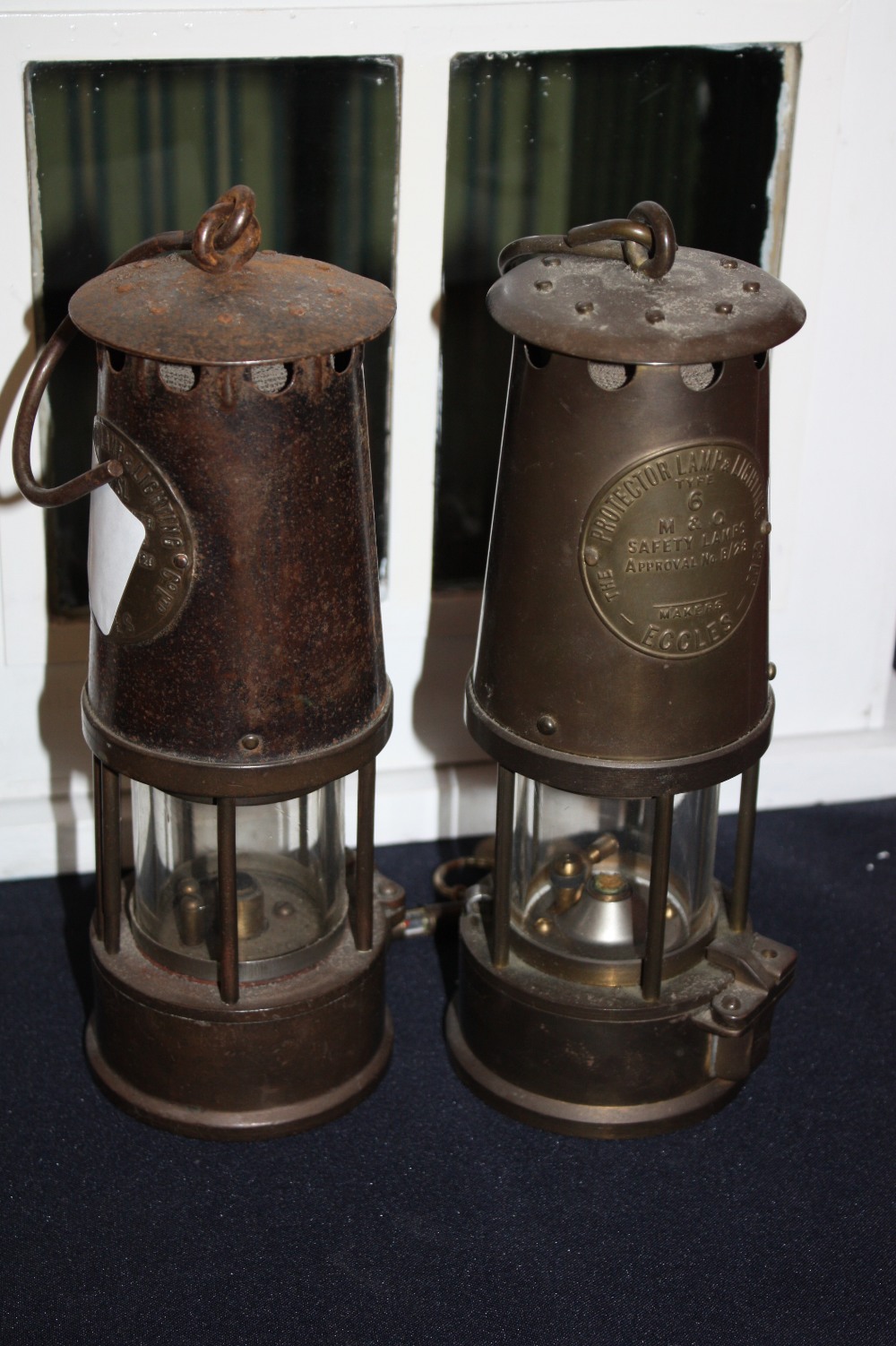Two Eccles brass miners lamps, one with colliery tag