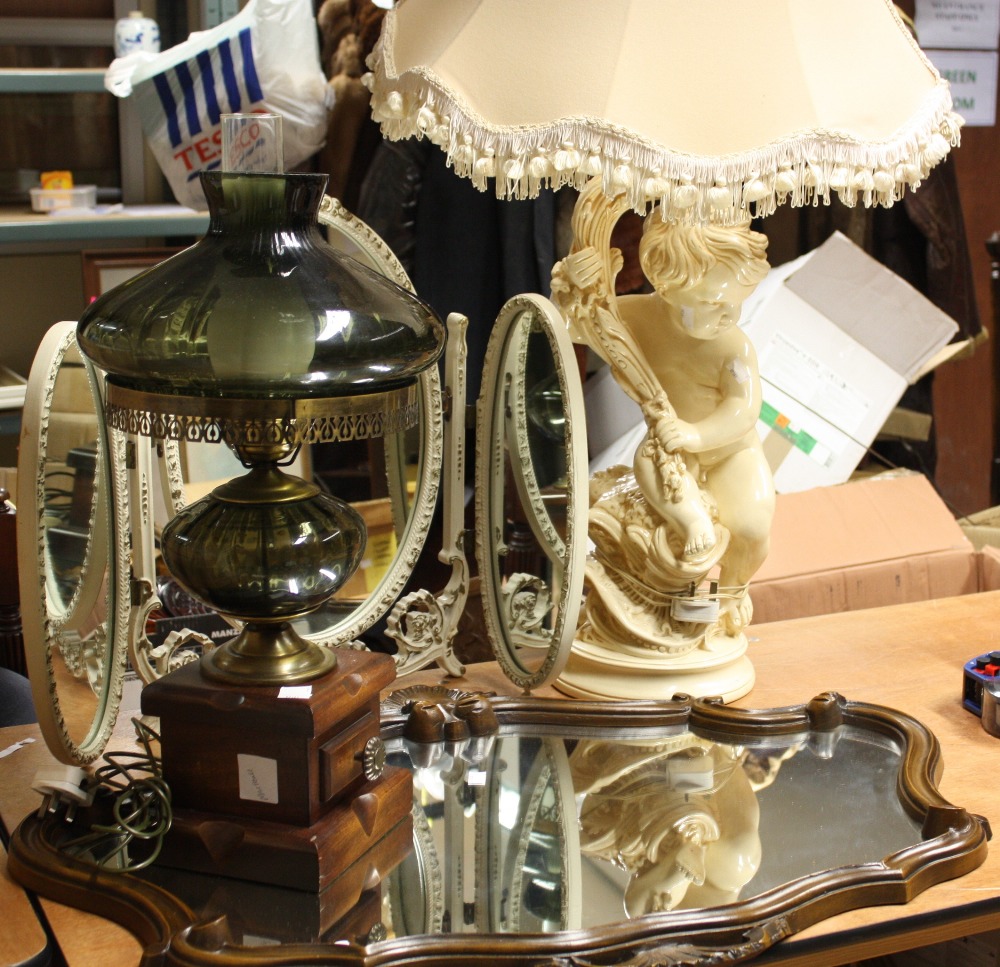 A plaster cupid lamp stand and shade; glass lantern style lamp; dressing table mirror; wooden framed