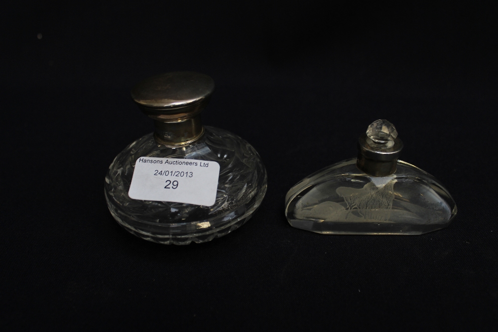 silver-topped cut-glass perfume bottles, Birmingham & Chester hallmarks. (2)