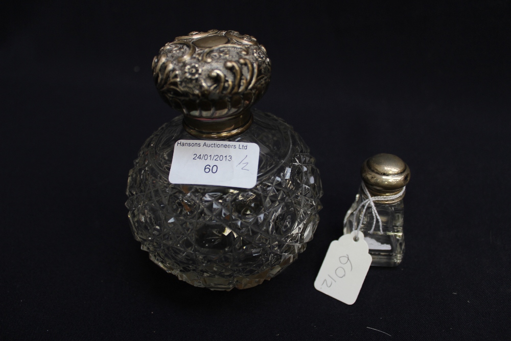 A hobnail-cut silver-topped scent bottle, Birmingham, 1903 and a silver-topped perfume bottle (2)