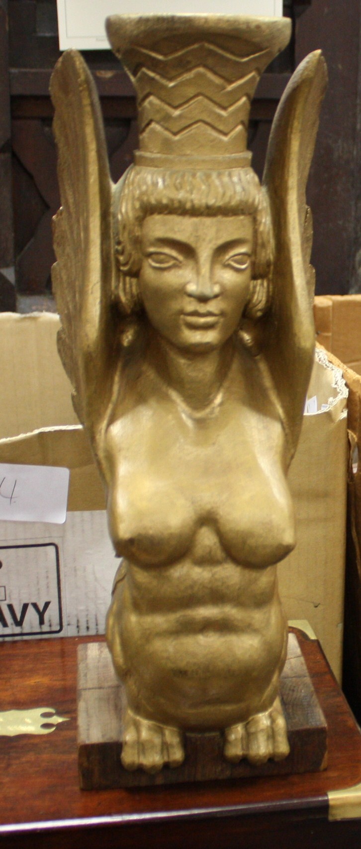 An Art Deco style carved-wood lamp base in the form of a sphinx