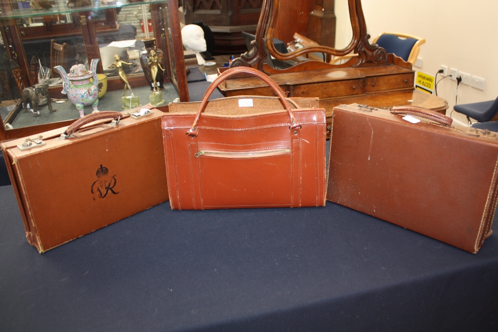 A monogrammed George VI suitcase, another suitcase and a leather carryall (3)