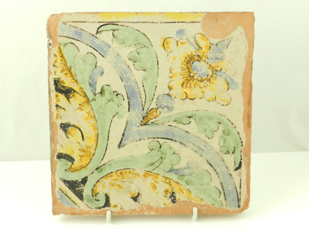 An early Italian Maiolica tile, decorated with stylized flowers and leaves in yellow, green and