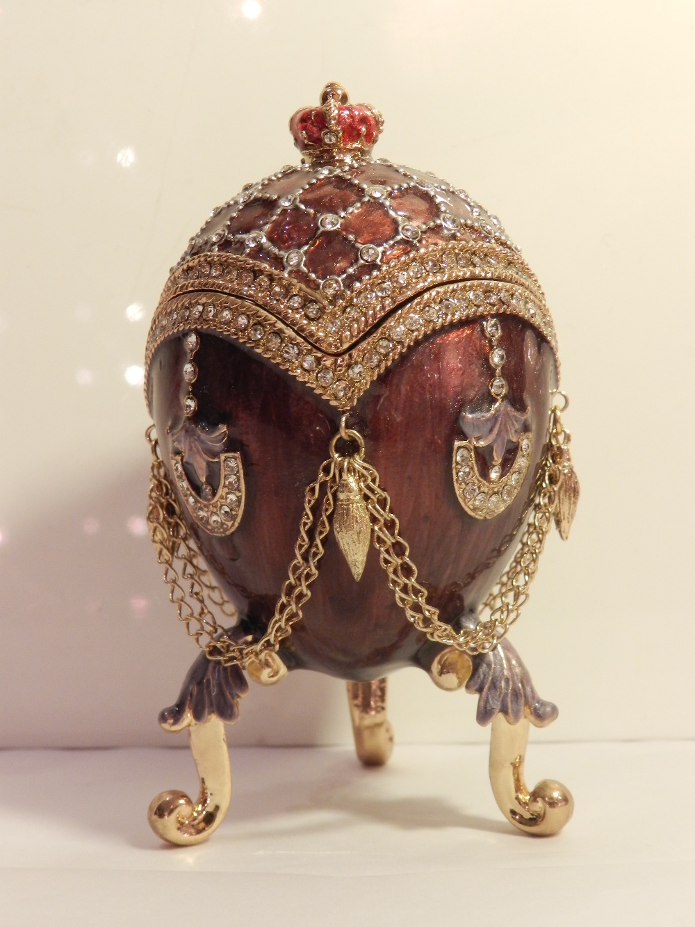 In the style of Carl Faberge, an enamelled gilt metal egg shaped box. H. 10 cm.