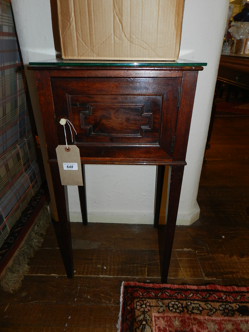 A George IV mahogany bedside cabinet, having single door on tapered legs.