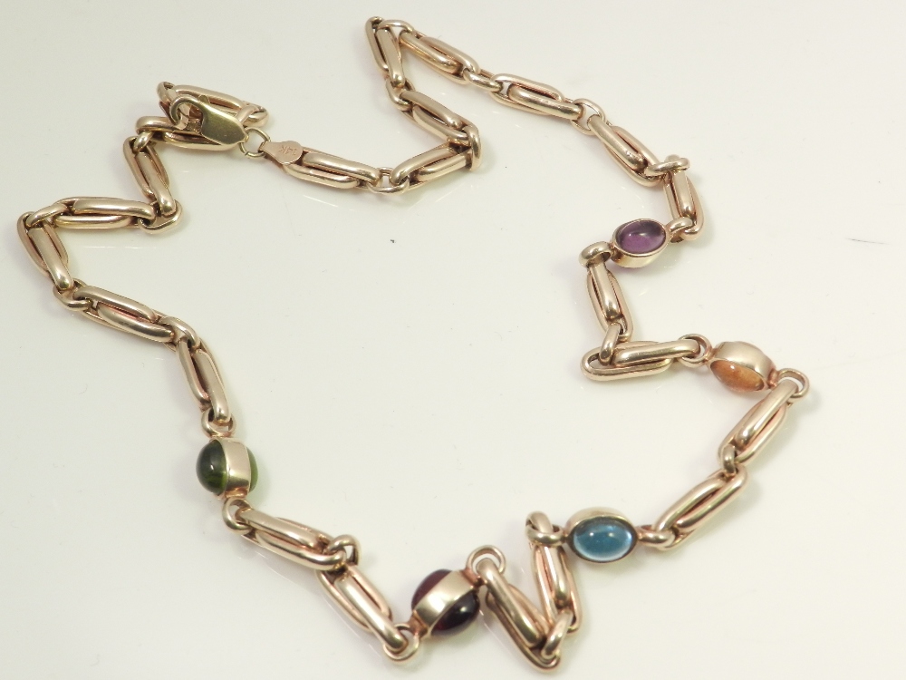 A ladies 14ct gold necklace, set with five semi-precious cabochon cut gemstones.