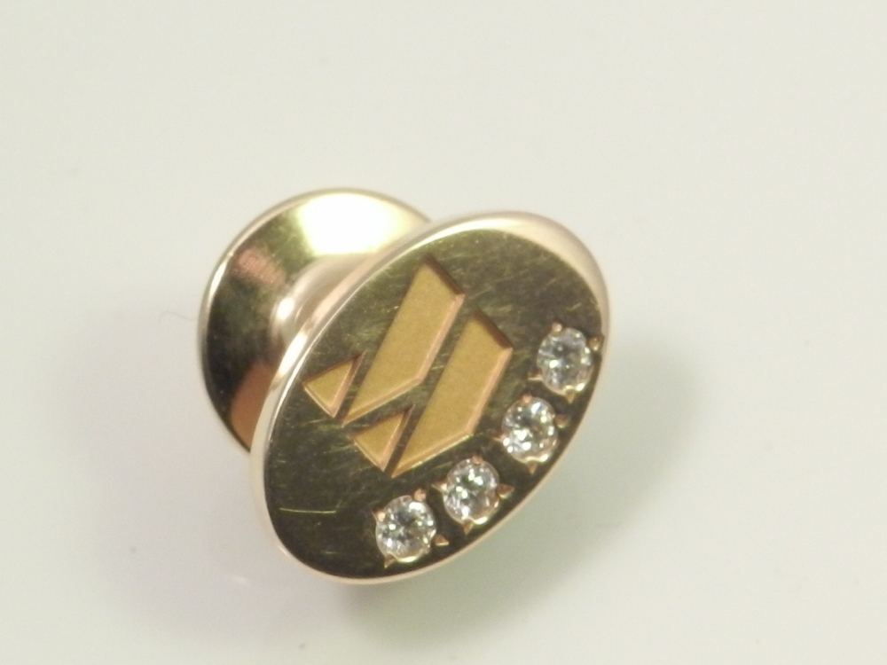 A 14ct gold tie pin, set with four diamonds.