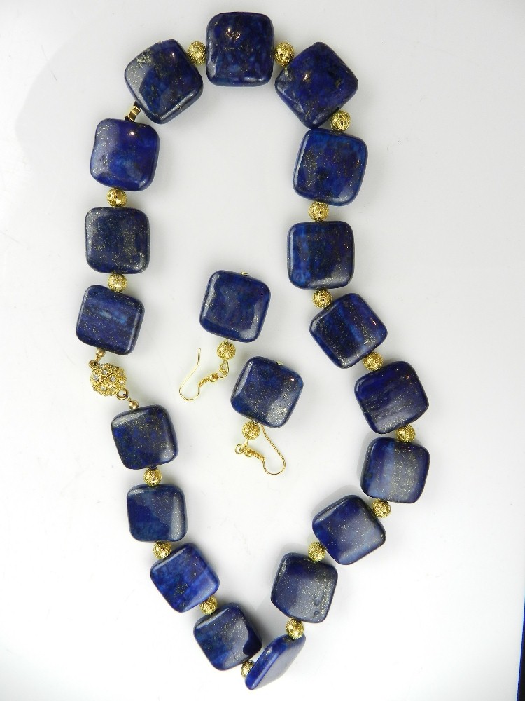 A contemporary necklace of flat square lapis lazuli beads spaced by pierced gold beads, with  gold