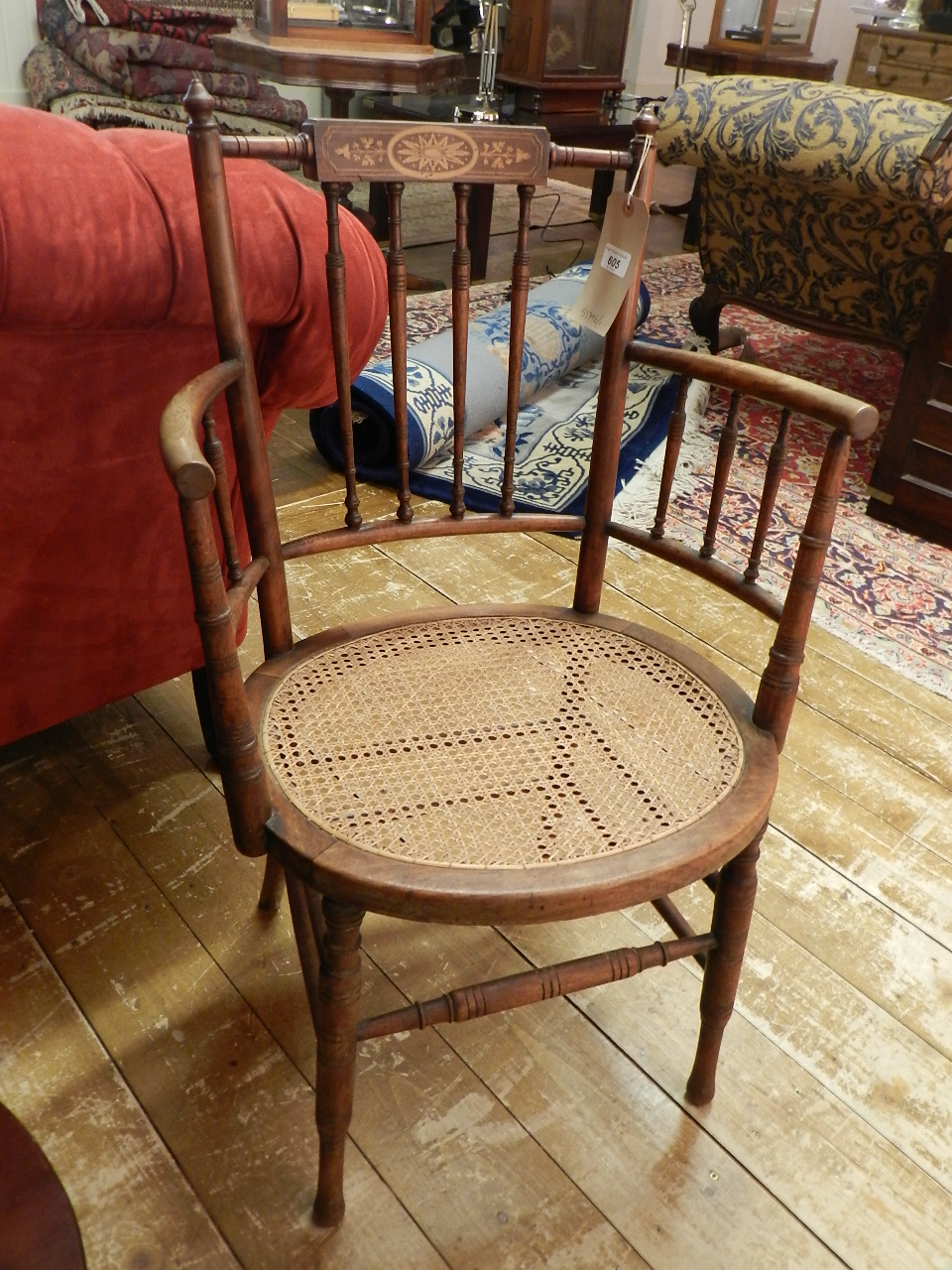 An Edwardian marquetry inlaid oak country elbow chair.