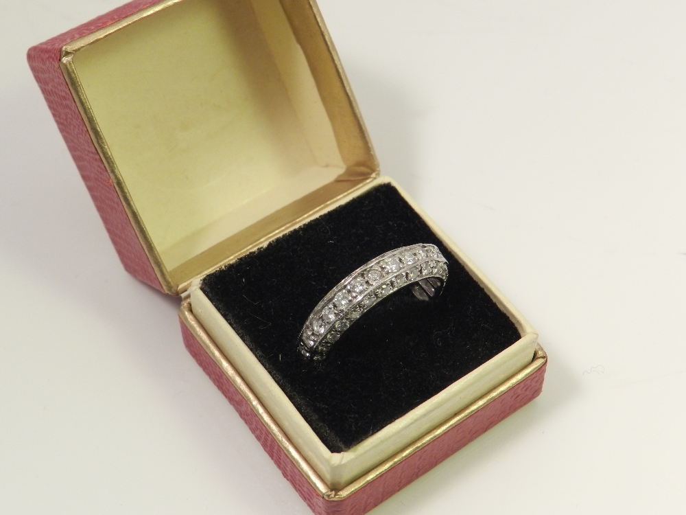 An 18ct white gold eternity ring, set with three rows of diamonds.