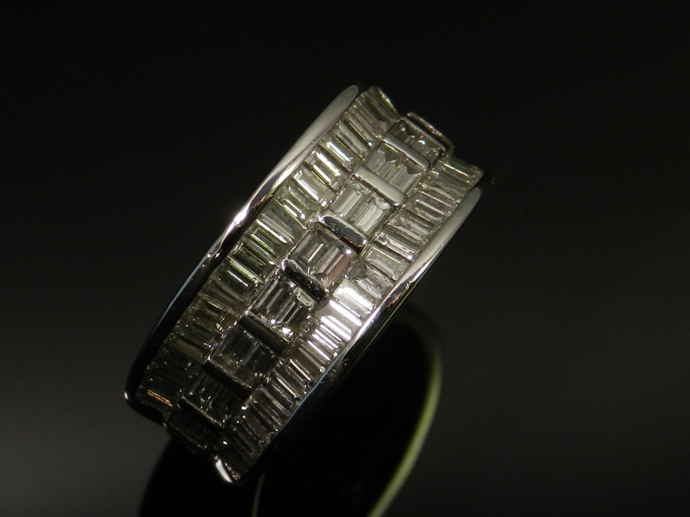 An 18ct white gold ladies dress ring, set with baguette cut diamonds.