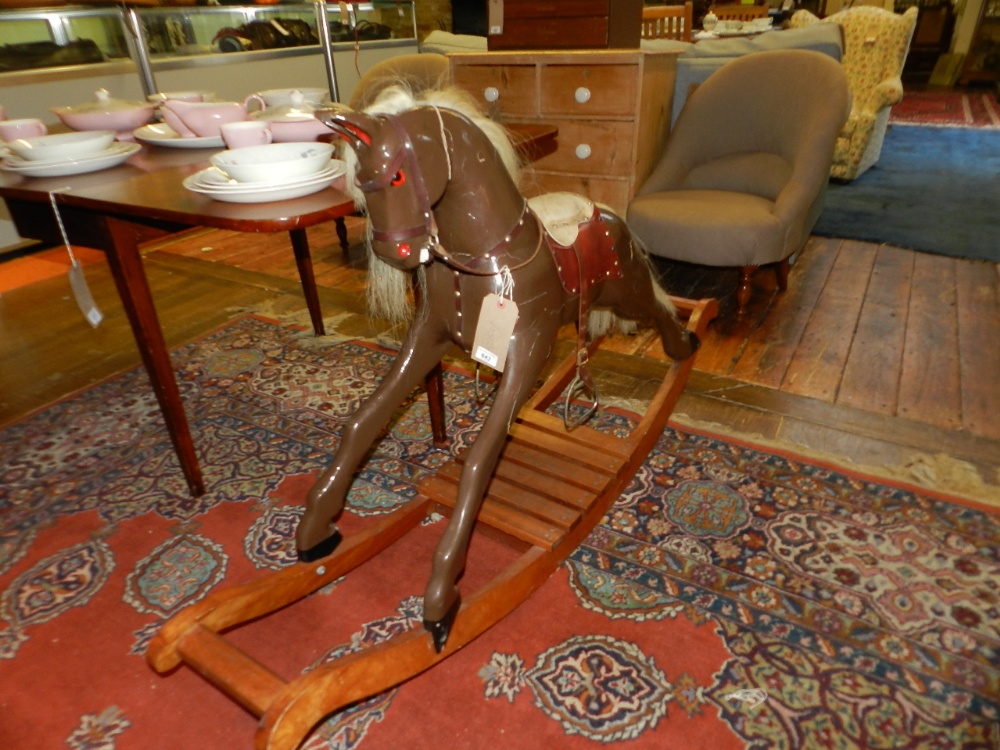 A contemporary painted pine rocking horse (A/F).