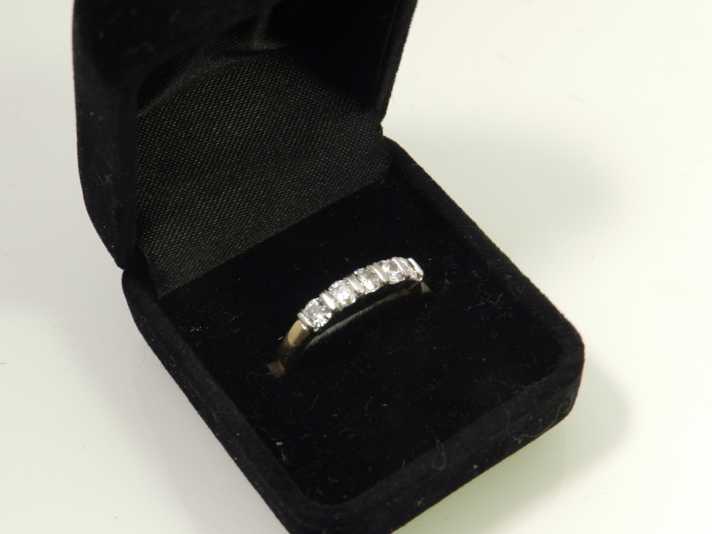 An 18ct gold and platinum mounted five stone diamond ladies dress ring.