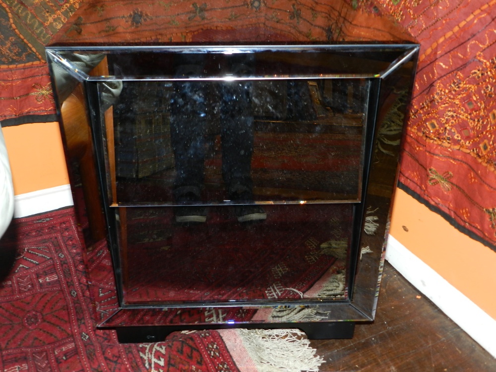 A pair of contemporary smoked mirror clad pedestal chests of two drawers.
