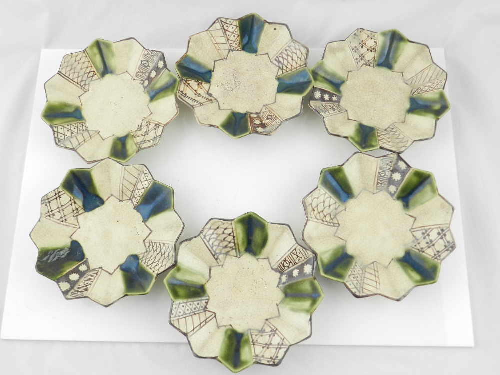 A set of six 20th century Japanese oribe crackle glaze pottery saucers of star form.