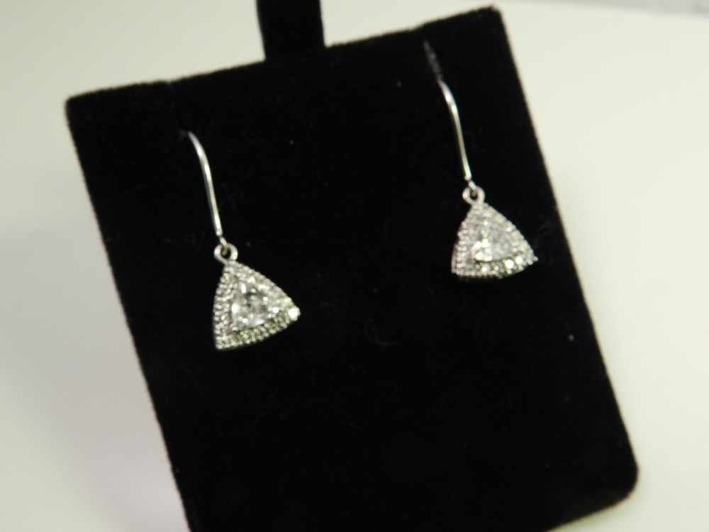 A pair of white metal and diamond earrings, set trillion and brilliant cut stones of approx. 1.25cts